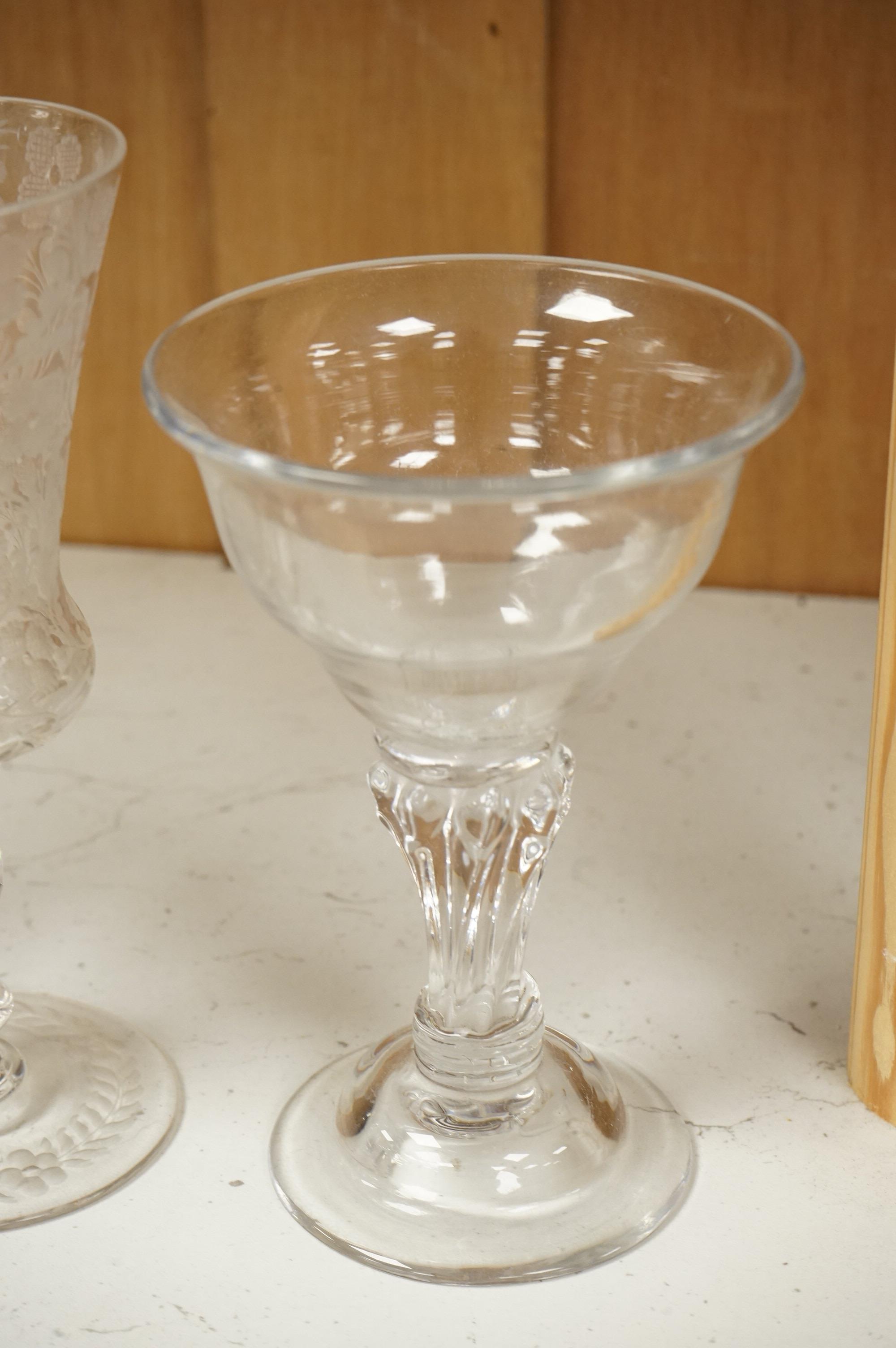 An 18th century sweetmeat glass, a 19th century large wheel engraved ‘Gretna Green’ goblet and a smaller floral engraved glass, tallest 23cm